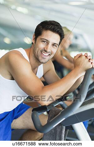 Man using exercise machine in gym View Large Photo Image Stock Photo - Man using exercise machine in gym. Fotosearch