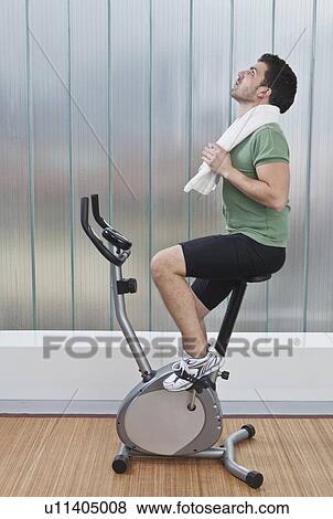 Man using exercise machine View Large Photo Image Stock Photo - Man using exercise machine. Fotosearch