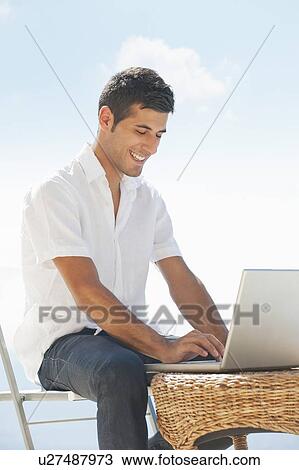 Man using laptop outdoors View Large Photo Image Stock Image - Man using laptop outdoors. Fotosearch