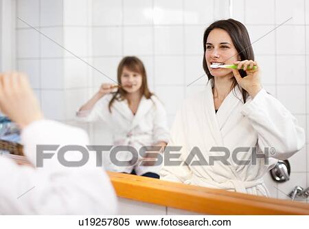 Mother and daughter brushing teeth View Large Photo Image Stock Photography - Mother and daughter brushing teeth. Fotosearch