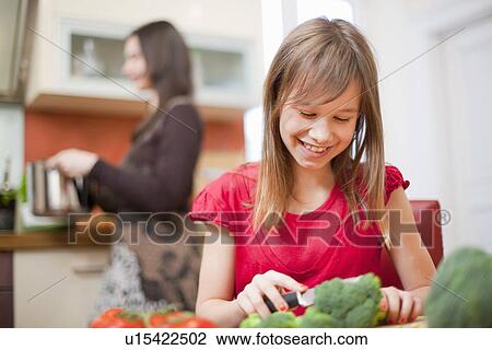 Mother and daughter cooking together View Large Photo Image Stock Image - Mother and daughter cooking together. Fotosearch