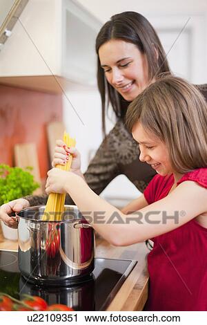 Mother and daughter cooking together View Large Photo Image Stock Image - Mother and daughter cooking together. Fotosearch