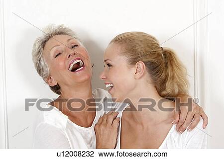 Stock Image - Mother and daughter laughing together. Fotosearch