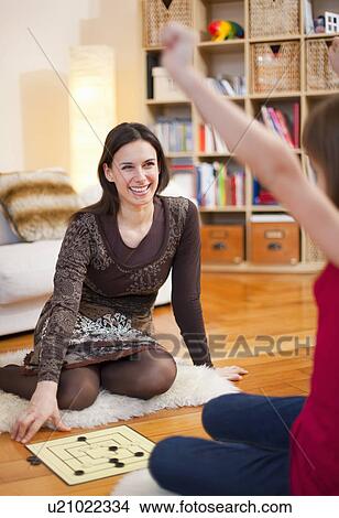 Mother and daughter playing board game View Large Photo Image Picture - Mother and daughter playing board game. Fotosearch