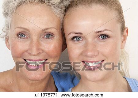 Stock Image - Mother and daughter smiling together. Fotosearch
