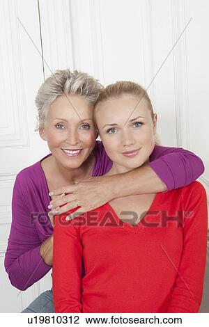 Stock Image - Mother and daughter smiling together. Fotosearch