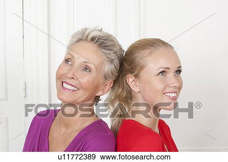 Mother and daughter smiling together View Large Photo Image Stock Photo - Mother and daughter smiling together. Fotosearch