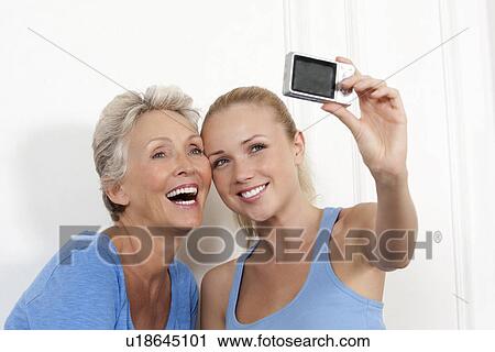 Stock Image - Mother and daughter taking photo. Fotosearch