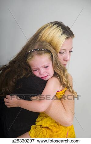 Mother comforting crying girl View Large Photo Image Stock Photo - Mother comforting crying girl. Fotosearch