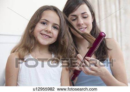 Mother curling daughters hair View Large Photo Image Stock Image - Mother curling daughters hair. Fotosearch