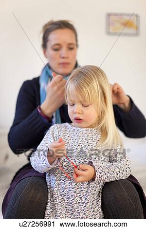 Mother doing daughters hair View Large Photo Image Stock Image - Mother doing daughters hair. Fotosearch