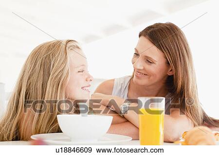 Mother talking to daughter at breakfast View Large Photo Image Stock Photo - Mother talking to daughter at breakfast. Fotosearch
