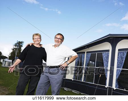 Older couple smiling outside tent View Large Photo Image Stock Photo - Older couple smiling outside tent. Fotosearch