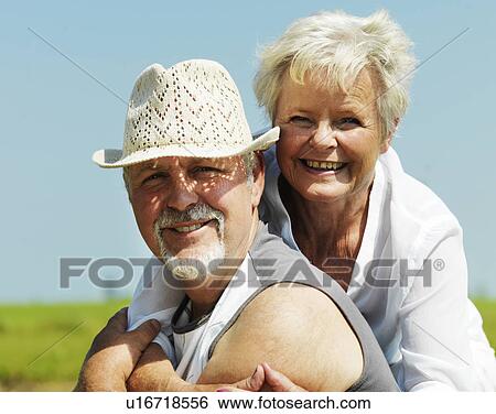 Older couple smiling together outdoors View Large Photo Image Stock Photograph - Older couple smiling together outdoors. Fotosearch