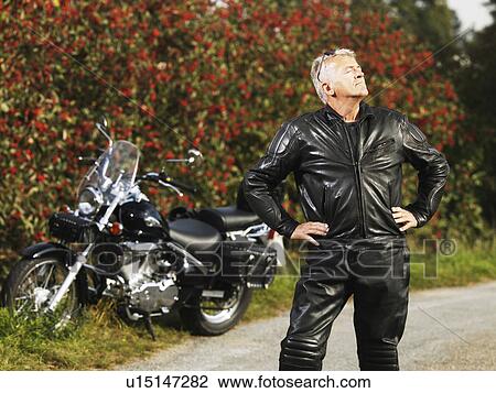 Older man in leather with motorcycle View Large Photo Image Stock Image - Older man in leather with motorcycle. Fotosearch