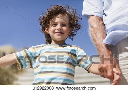 Older man walking with grandson View Large Photo Image Stock Photo - Older man walking with grandson . Fotosearch