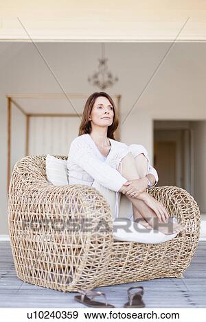 Older woman relaxing in armchair View Large Photo Image Stock Photo - Older woman relaxing in armchair. Fotosearch