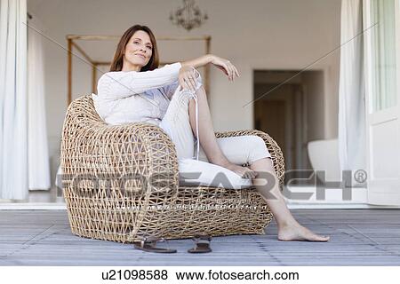 Older woman relaxing in armchair View Large Photo Image Stock Photo - Older woman relaxing in armchair. Fotosearch