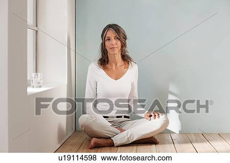 Older woman sitting on floor in studio View Large Photo Image Stock Photo - Older woman sitting on floor in studio. Fotosearch