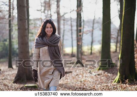Older woman walking in forest View Large Photo Image Stock Image - Older woman walking in forest. Fotosearch