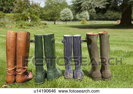 Stock Photograph - Pairs of boots standing in field. Fotosearch