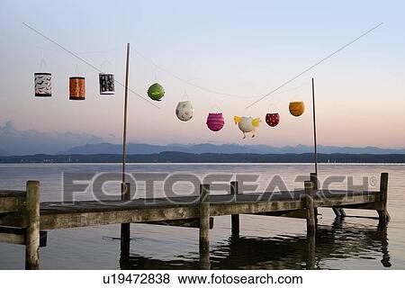 Stock Photo - Paper lanterns strung up on wooden pier. Fotosearch