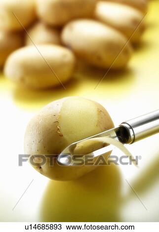 Peeler removing potato skin View Large Photo Image Stock Image - Peeler removing potato skin. Fotosearch