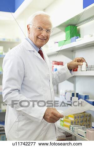 Pharmacist filling prescription View Large Photo Image Stock Photo - Pharmacist filling prescription. Fotosearch