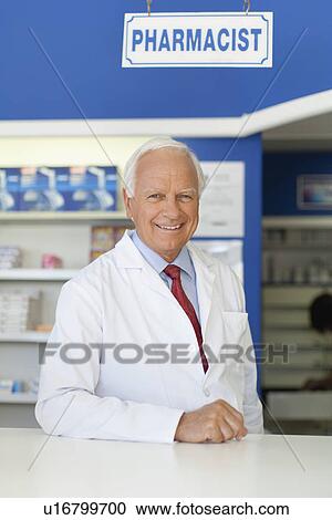 Pharmacist smiling at counter View Large Photo Image Stock Image - Pharmacist smiling at counter. Fotosearch