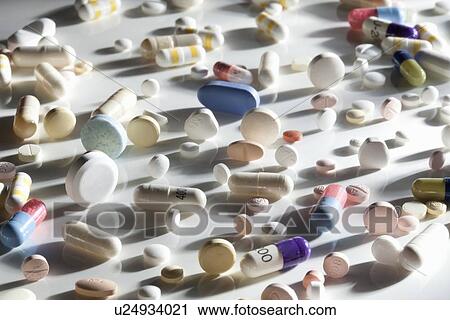 Pills scattered on reflective surface View Large Photo Image Stock Image - Pills scattered on reflective surface. Fotosearch