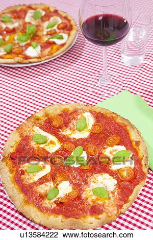 Pizzas on checkered tablecloth View Large Photo Image Stock Image - Pizzas on checkered tablecloth. Fotosearch