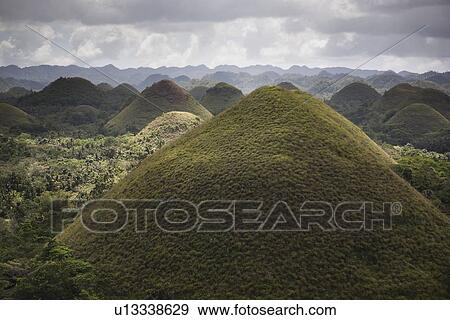 Pointed hills in rural landscape View Large Photo Image Stock Photo - Pointed hills in rural landscape. Fotosearch