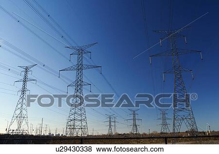 Power lines against blue sky View Large Photo Image Stock Photo - Power lines against blue sky. Fotosearch