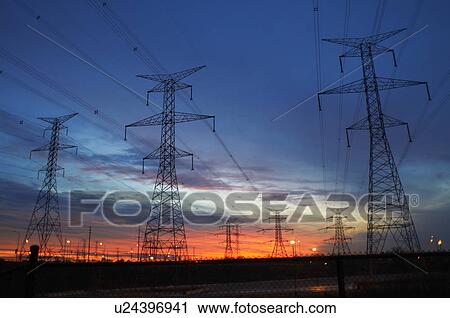Stock Image - Power lines against sunset sky. Fotosearch