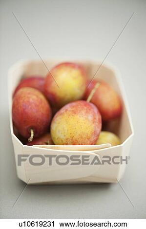 Stock Image - Punnet of Victoria plums. Fotosearch