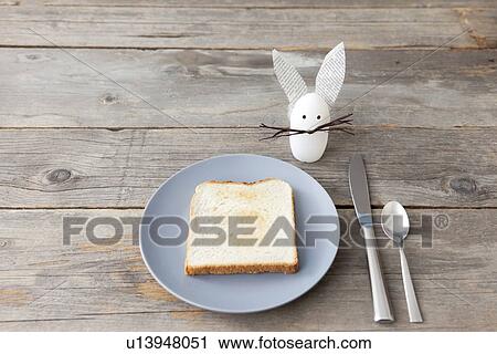 Stock Image - Rabbit decoration and plate of toast. Fotosearch
