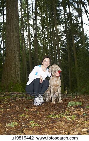 Runner smiling with dog in forest View Large Photo Image Stock Image - Runner smiling with dog in forest. Fotosearch