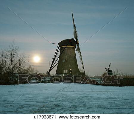 Rural windmill on frozen river View Large Photo Image Stock Image - Rural windmill on frozen river. Fotosearch