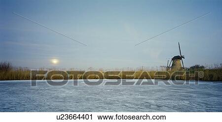 Rural windmill on frozen river View Large Photo Image Stock Image - Rural windmill on frozen river. Fotosearch