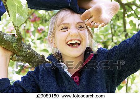 Smiling children climbing tree together View Large Photo Image Stock Image - Smiling children climbing tree together. Fotosearch