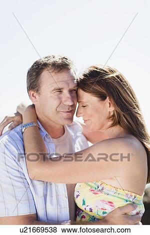 Smiling couple hugging outdoors View Large Photo Image Stock Photo - Smiling couple hugging outdoors. Fotosearch