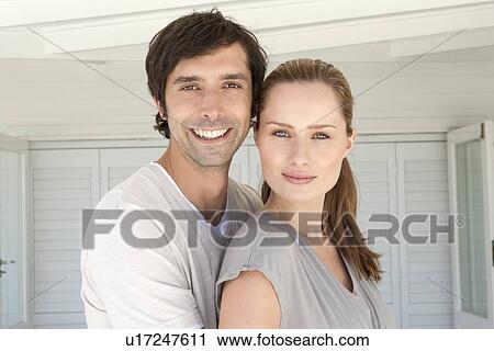 Smiling couple standing together View Large Photo Image Stock Image - Smiling couple standing together. Fotosearch