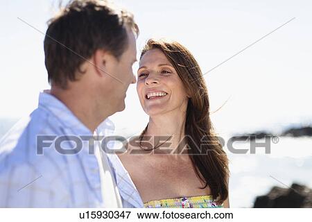 Stock Photo - Smiling couple walking outdoors. Fotosearch