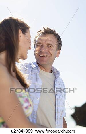 Smiling couple walking outdoors View Large Photo Image Stock Photo - Smiling couple walking outdoors. Fotosearch
