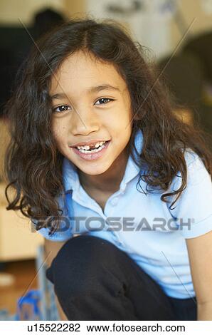 Smiling girl showing gap in teeth View Large Photo Image Stock Image - Smiling girl showing gap in teeth. Fotosearch
