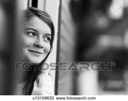 Smiling girl standing in doorway View Large Photo Image Stock Image - Smiling girl standing in doorway. Fotosearch