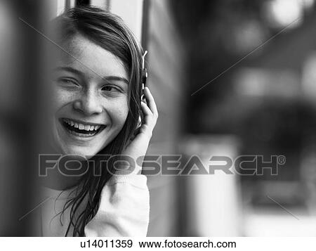 Smiling girl talking on cell phone View Large Photo Image Stock Photo - Smiling girl talking on cell phone. Fotosearch