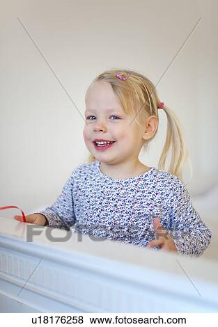 Smiling girl wearing pigtail View Large Photo Image Stock Photo - Smiling girl wearing pigtail. Fotosearch