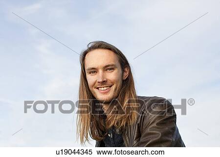 Smiling man standing outdoors View Large Photo Image Stock Photography - Smiling man standing outdoors. Fotosearch