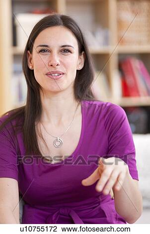 Smiling woman talking on sofa View Large Photo Image Stock Image - Smiling woman talking on sofa. Fotosearch